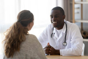a woman discusses her options for medication assisted treatment for addiction with her addiction treatment specialist