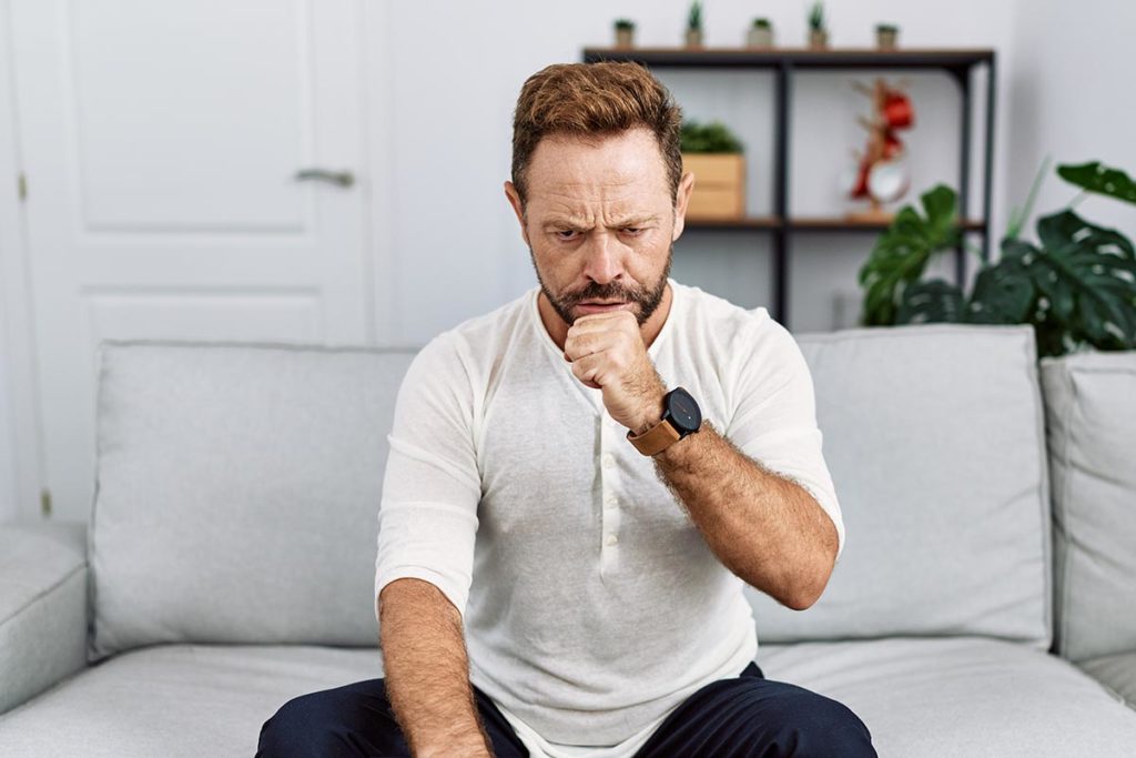 a man is upset after hearing about the long term effects of his alcoholism in treatment