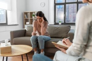 a woman opens up in an alcohol addiction treatment program
