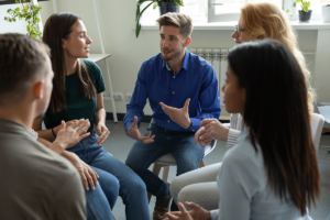 a therapy group meets within a residential addiction treatment program